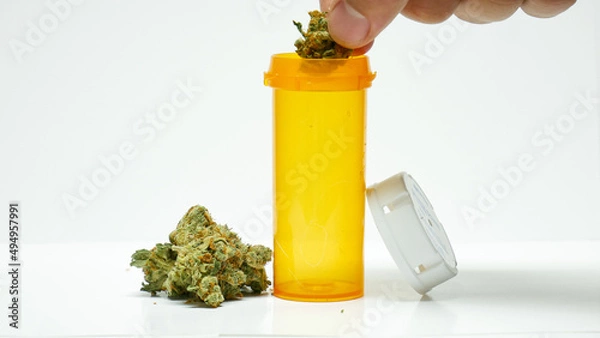 Obraz Cannabis dropped into bottle