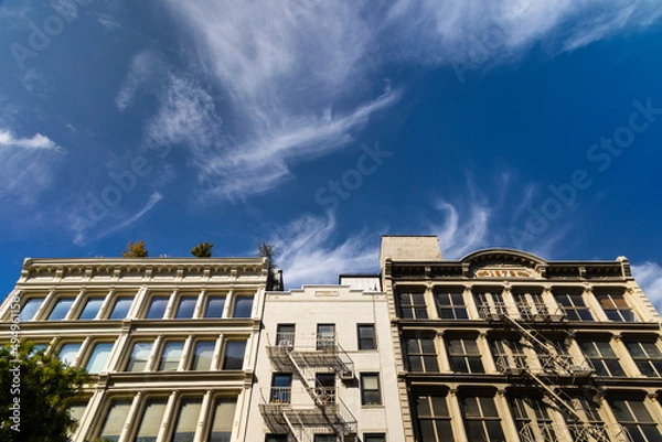 Fototapeta Rows of Loft buildings stand along the street in SOHO district on October 15, 2021 in New York City NY USA. 