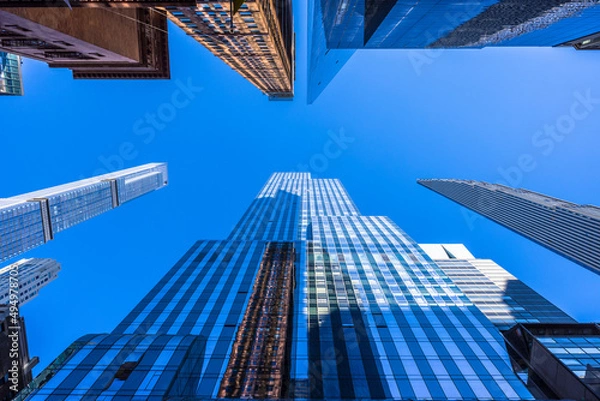 Fototapeta Newly built ultra luxury high-rise residential buildings stand on West 57th street in Billionaires’ Row among Midtown Manhattan skyscraper on November 8, 2021 in New York City NY USA. In the front row