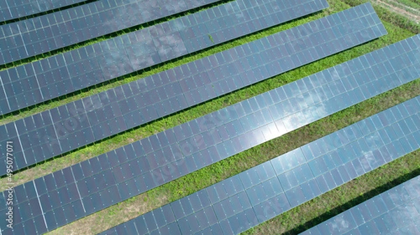 Fototapeta Aerial top view of solar panels or solar cells farm, renewable energy source. Ecotechnology for electric power in the industry.