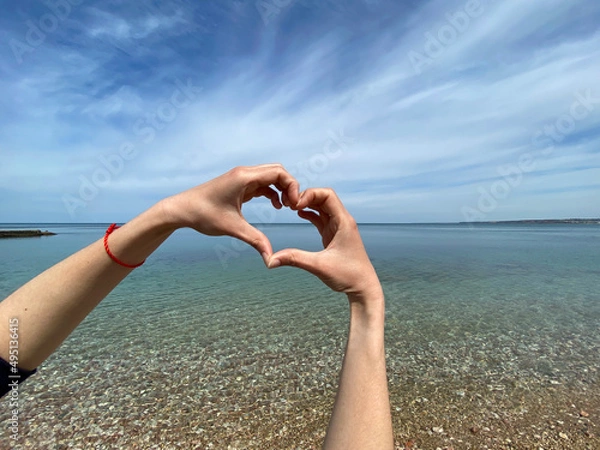 Obraz heart from hands on the background of the sea