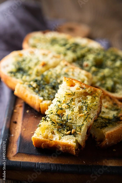 Fototapeta Crispy bread with garlic butter and dill