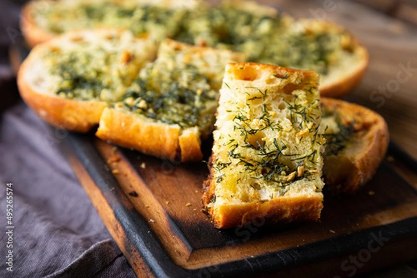 Fototapeta Crispy bread with garlic butter and dill