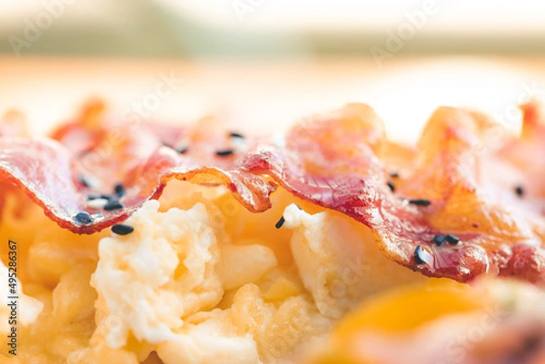 Fototapeta Scrambled eggs with bacon avocado and orange juice