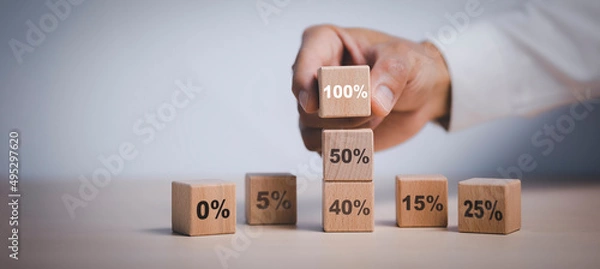 Fototapeta Hand chosen cube with check percent symbol printed on its one side, viewed in close-up, Interest rate financial and mortgage rates, Increasing interest rates or discount sale concept,sale and discount