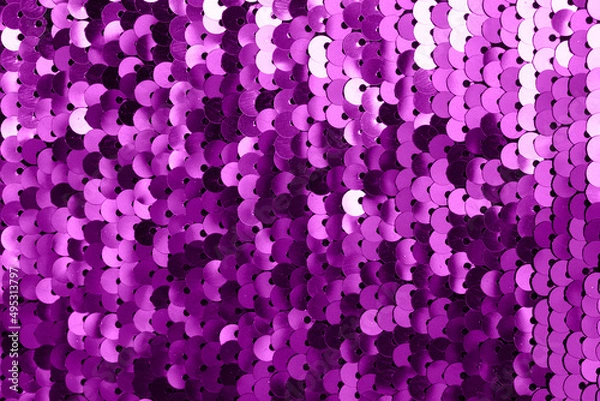 Fototapeta Background of fabric with sequins. A close-up shot of a shiny texture made of purple sequins