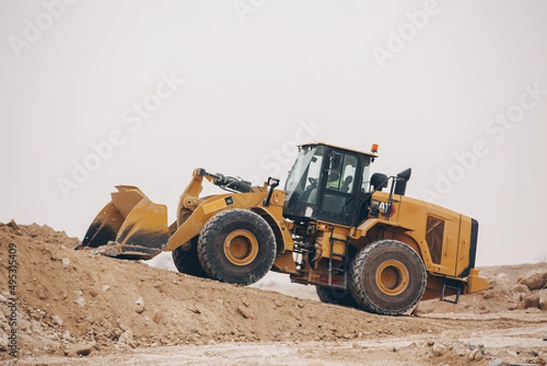 Fototapeta Dozer, excavator, and road rollers working on the mud site