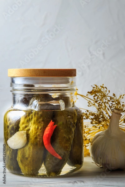 Fototapeta Pickled cucumbers in a jar.