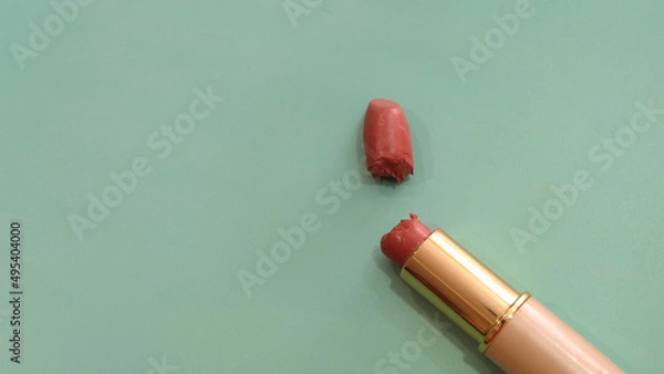 Obraz Top view of a tube of lipstick that is broken into half. With copy space on the left.