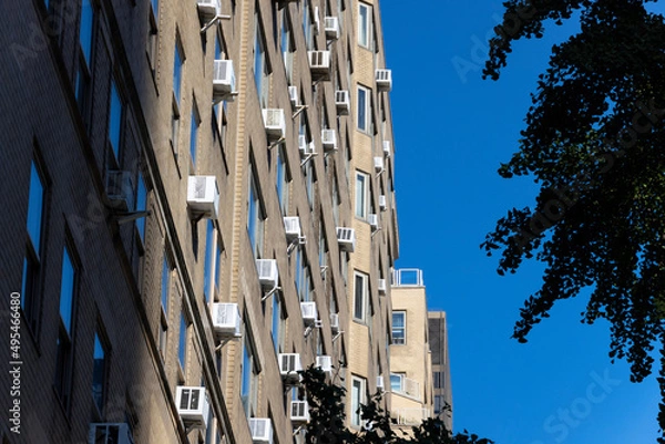 Fototapeta Many air conditioners installed at windows of residential buildings along Park Avenue in Midtown Manhattan on October 21, 2021 in New York City NY USA.