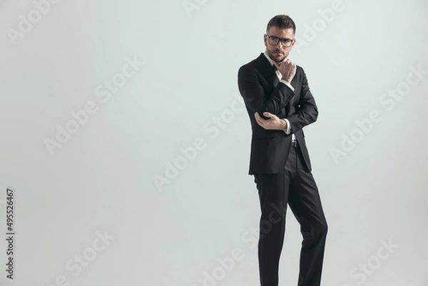 Fototapeta businessman in his middle age is holding his elbow