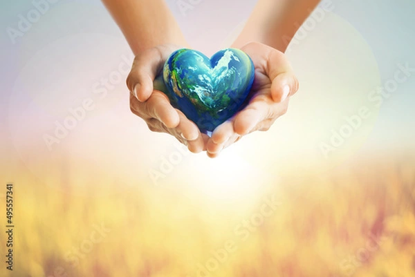 Obraz Human Hands holding Earth ball in heart shape on pastel background for World Health Day content and copy space.Elements of this image furnished by NASA