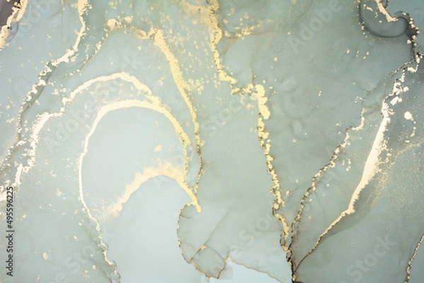 Fototapeta Luxury abstract fluid art painting in alcohol ink technique, mixture of gray and gold paints. Imitation of marble stone cut, glowing golden veins. Tender and dreamy design.