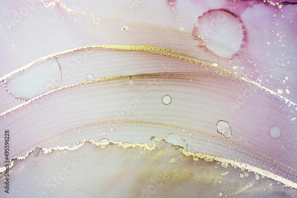Fototapeta Luxury abstract painting in fluid art technique.Transparent layers of pastel pink and gold paints create marbled texture of stripes, swirls and veins with glowing gold and glitter. Natural beauty