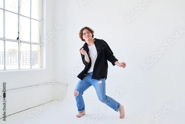 Obraz man dancing by window smiling