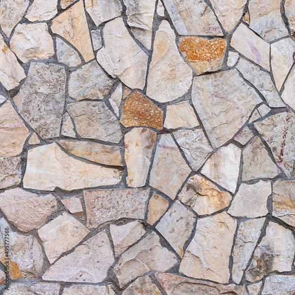 Fototapeta Old stone wall of stones of different sizes and colors as a natural background