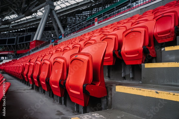 Fototapeta Rows of seats in a football stadium. Bright red stadium seats