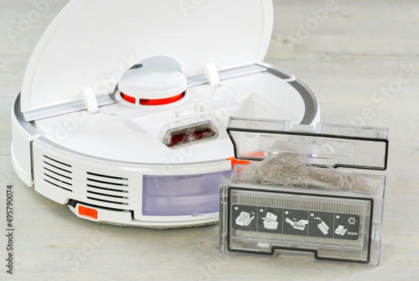 Fototapeta robot vacuum cleaner water tank removed and the filter lid is opened to clean. Smart cleaning and washing technology. advanced robot to vacuum then mop. close up
