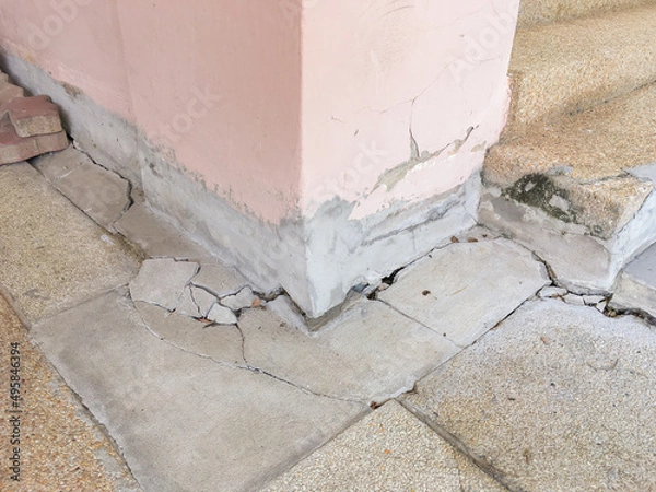 Fototapeta Collapsed or cracked concrete basement floor and pole