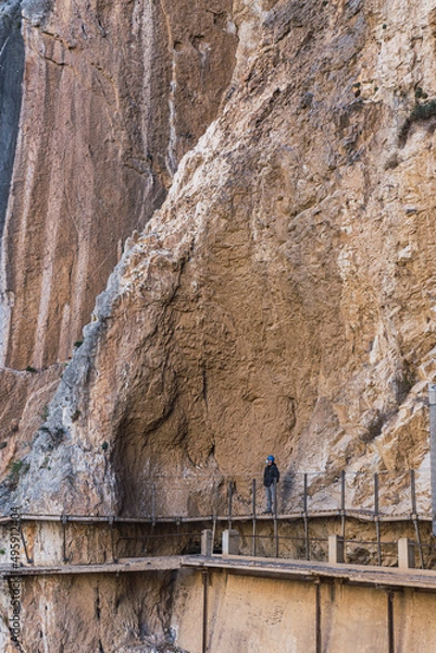 Fototapeta Man with helmet looking at the rocks in the King's little pathway, Andalusia, Spain.