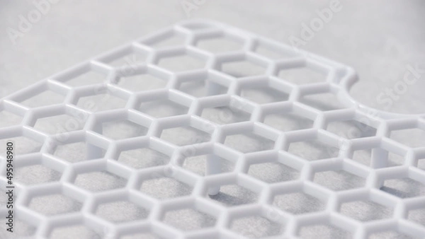 Obraz Rejilla de plástico blanco con celdas hexagonales