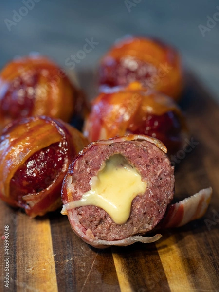 Fototapeta Meatballs filled with cheddar cheese and wrapped with bacon known as moinkballs