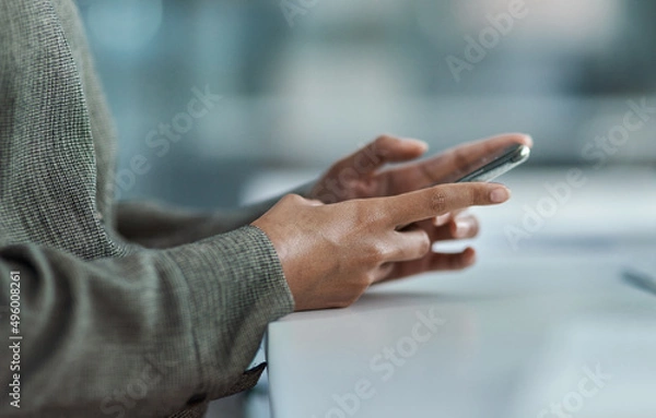Fototapeta Technology as my fingertips. Cropped image of an unrecognisable businesswoman using her mobile phone in the office.