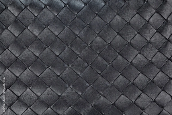 Fototapeta Texture of braided genuine leather of excellent workmanship in a black color. A great background for the banner. Horizontal arrangement.