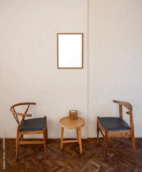 Fototapeta Wooden armchair with table and empty picture frame in living room