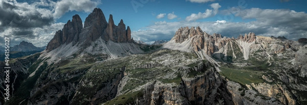 Fototapeta Mountain panorama with Paternkofel and Thre Peaks mountain summit in the Dolomite Alps in South Tyrol with clouds in dark sky.