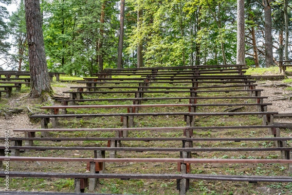 Fototapeta Empty Wooden Bench Rows in Park for Outdoor Events