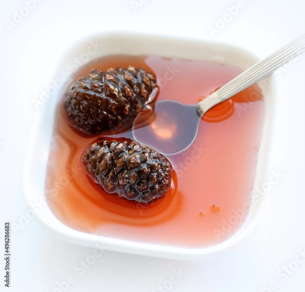 Obraz Pine cones jam on white background, on table. Top view.