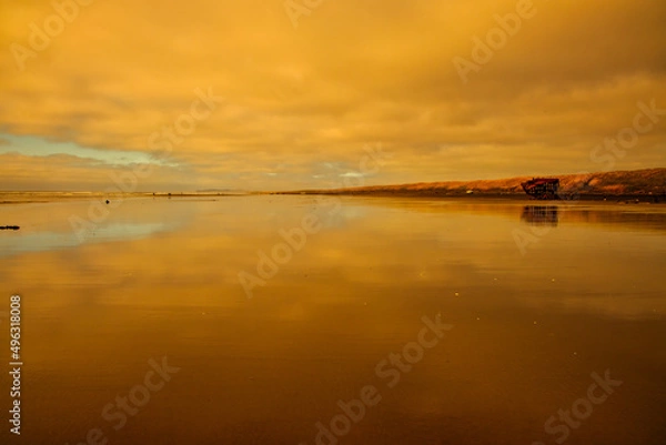 Fototapeta clouds and sky reflection on wet sand