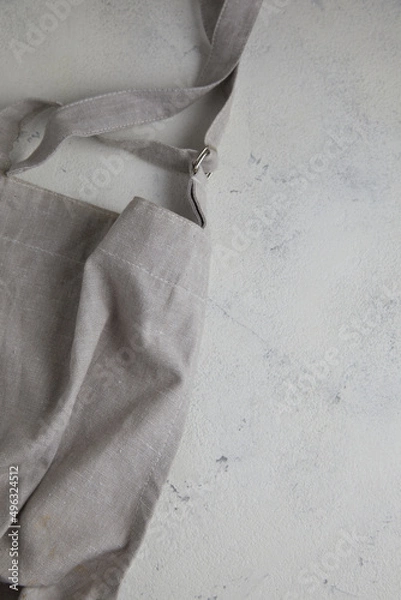 Fototapeta Apron on light rust textured background. Copy space.