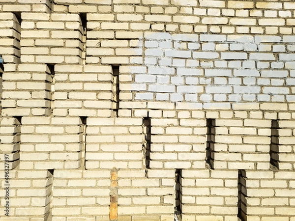 Fototapeta Textured yellow brick wall. Space for text. Horizontal format.