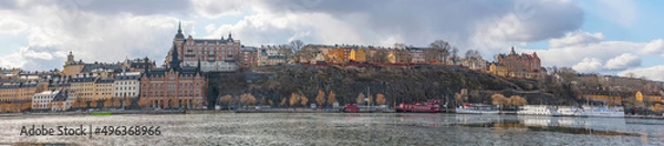 Fototapeta Panorama view over the district Södermalm blocks with houses from the 1700s and the view point board walk Montelius a sunny spring day in Stockholm