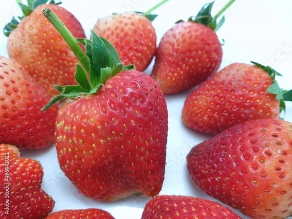 Obraz Heap of fresh strawberries isolated on white background, Strawberry as a background ,Selective focus, Fresh fruit ready to eat or making drinks and salads, Healthy concept