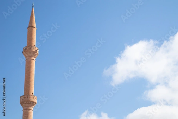 Fototapeta Minaret of the mosque against of blue sky