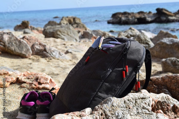 Obraz glasses and passport in a backpack on the beach