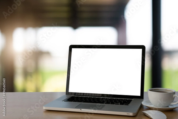 Fototapeta laptop on a table blurred background light bokeh.	