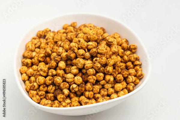 Obraz Kurkura Chana Dal Masala Namkeen Mixture Also Called Kurkure Kala Channa Dalmoth Nimki Is Made Of Bhuna Bengal Gram Roasted In Garam Masala Spices. Isolated On White Background With Copy Space