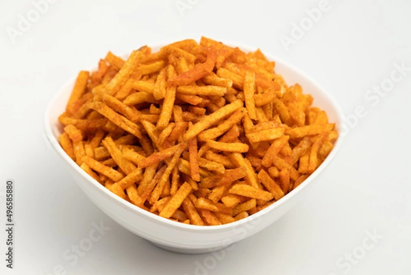 Fototapeta Namkeen Kurkura Kacchi Aloo Sev Stick Bhujia Chips Or Kurkure Aaloo Seb Bhujiya Lachha Mixture Fryums Are Made Of Sliced Potato With Garam Masala Spices. Isolated On White Background With Copy Space