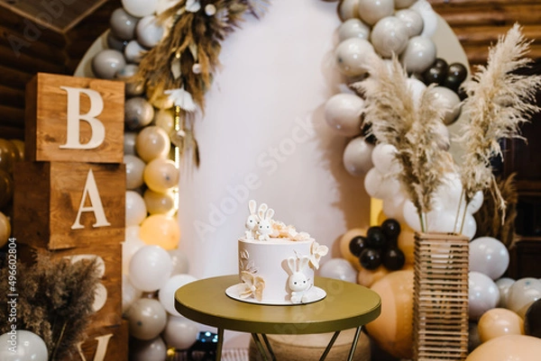 Fototapeta Birthday Cake on a background balloons party decor. Baby shower party, decor. Celebration baptism concept. Copy space. Celebration concept. Trendy Cake. Delicious reception.