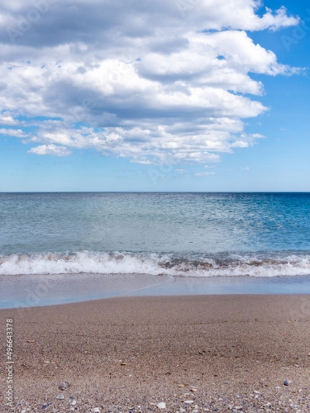 Fototapeta Beautiful beach, sea and cloudy blue sky. Scenic view of cloudscape in blue sky over sandy beach.