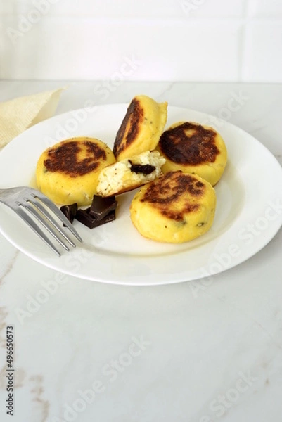 Fototapeta Syrniki, cottage cheese fritters with chocolate, minimalist style, vertical, copy space