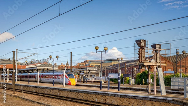 Fototapeta Trains at a station platform.