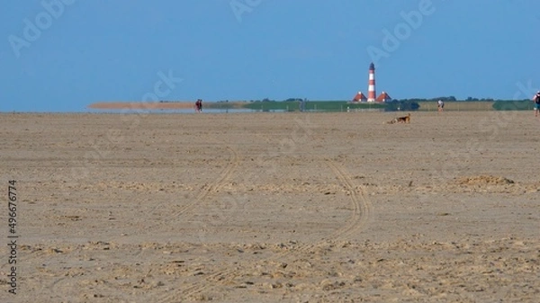 Fototapeta Westerheversand lighthouse as seen from the beach