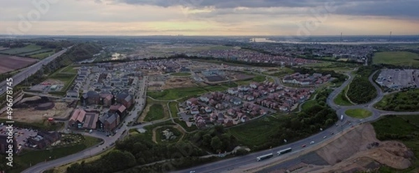 Fototapeta Aerial drone. Ebbsfleet Garden City new builds development with London skyline in the distance. Typical British homes and green gardens. Real estate and buildings concept.