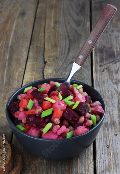 Fototapeta Vinaigrette traditional russian salad with boiled vegetables on wooden background with copy space