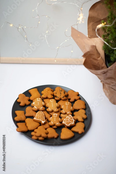 Obraz Shaped gingerbread cookies in the form of men and bells on a gray plate